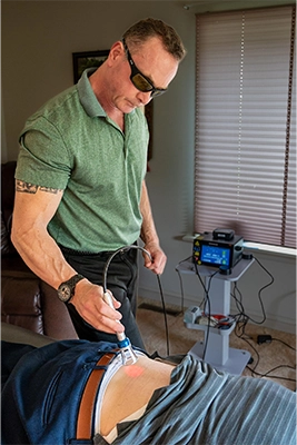 Chiropractor-Lewes-DE-Chris-Chalk-Using-Laser-Machine