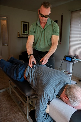 Chiropractor-Lewes-DE-Chris-Chalk-Using-PEMF-Machine-On-Patient